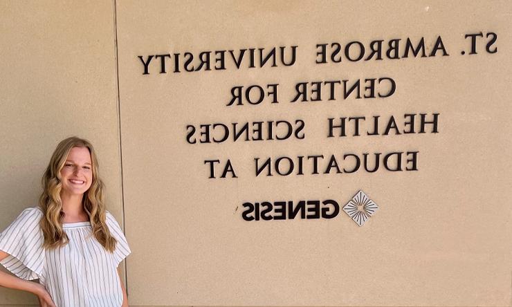 Natalie Cremer stands in front of the SAU Center for Health Sciences building